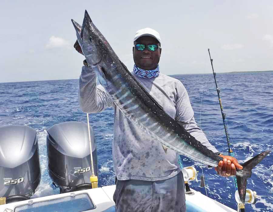 Deep sea fishing belize Jermaine holding a large Wahoo