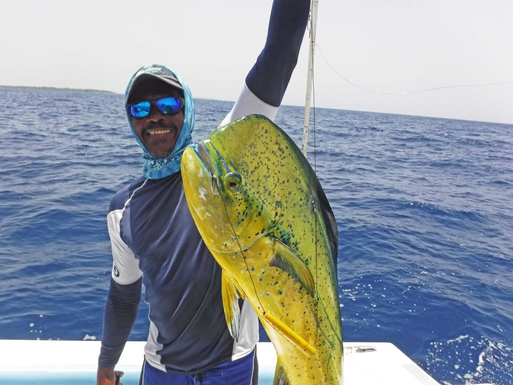Belize Fishing Charters Man holding a Dorado